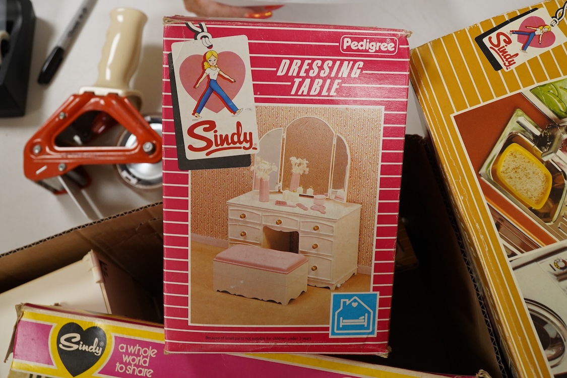 A collection of boxed Sindy doll furniture and accessories, including; a motorcycle (44384), a writing bureau (44512), a hostess trolley, a dressing table, a camping scene, a washing machine unit, together with boxed ite
